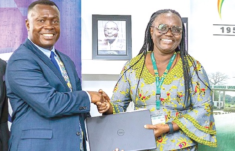 Mawuko Afadzinu, Head of Marketing and Communication at Stanbic Bank, presenting a laptop to Prof. Rita Akosua Dickson, VC of KNUST