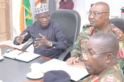 Ambassador Abdul-Fatau Musah (left),  Leader of the ECOWAS delegation, interacting with Major General Michael Amoah-Ayisi (middle), Commander of MNJTF 
