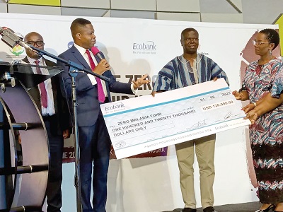 Dr Edward Botchway (left) presenting the dummy cheque for $120,000 to Dr Keziah Malm (right) and Dr Baffour Awuah