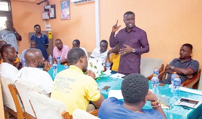 Jefferson Kwamina Sackey (standing), Deputy Director of Communications at the Office of the President,  addressing executive members of the association