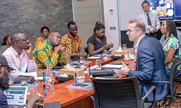 Trevor Kuna (right), Chief Transformation and Reputation Officer of QNET, interating with some journalists
