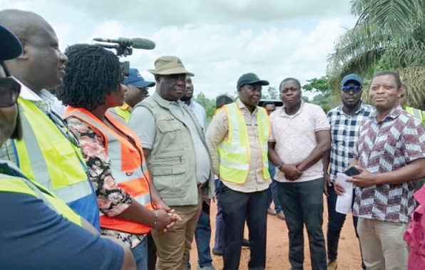 Kwasi Amoako-Attah (3rd from left) being briefed on the state of work on the Assin Asempaneye-Assin Kushea road project