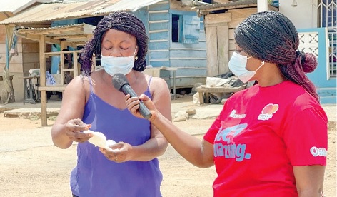 A market woman engaging a community member on menstrual pads 