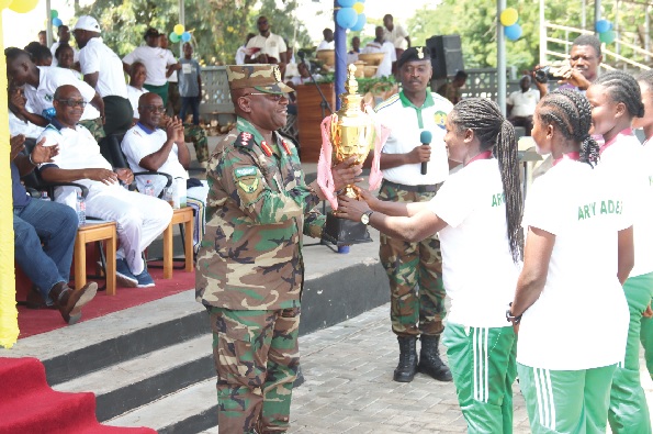 • Ghana Army Ladies, Women’s Premier League Super Cup champions, presenting the trophy to Maj Gen Thomas Oppong-Preprah (left), Chief of Army Staff, during the ceremony. Pictures: ELVIS NII NOI DOWUONA