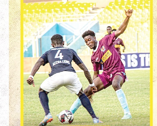 •Accra Lions defender Ali Mohammed (left) is challenged by a Kpando Heart of Lions player during yesterday’s match