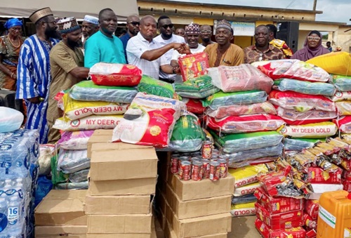 Samuel Okudzeto Ablakwa (4th from left), MP for North Tongu, receiving the items on behalf of the community, from Alhaji Baba Sharif Abdulai (3rd from right), CEO of Marhaba FM