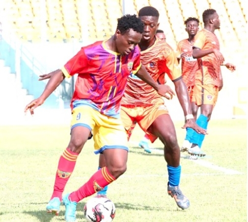 Hearts of Oak's Hamza Issah controls the ball away from his Legon Cities marker during the game