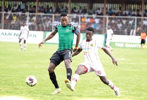 FC Samrtex lon-goal hero, Emmanuel Keyeke (left) gains the upper hand during a tussle with Andrews Ntim Manu of Kotoko in last Saturday's clash