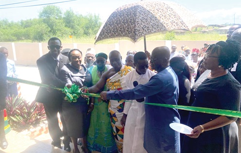 The Distric Court at Effia Kwesimintsim in the Western Region. Inset: Gertrude Torkornoo (2nd from left), Chief Justice,   being assisted by Nana Egya Kwamena XI, Chief of Apremdo, to cut the tape for the inauguration of the building