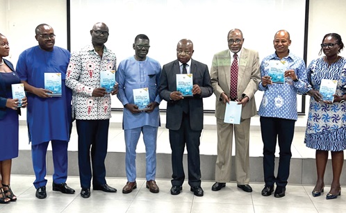 Kwaku Agyeman-Manu (middle), Minister of Health, with other dignitaries displaying the manual at the launch 