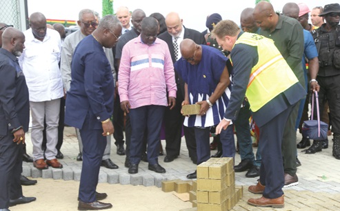 President Akufo-Addo (bent) laying a brick for the next stage of the expansion project at the MPS,Tema. With them is Kwaku Ofori Asiamah (4th from left), Minister of Transport, and Mohamed Samara (3rd from right), CEO, MPS. Picture: SAMUEL TEI ADANO