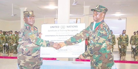 Major General Thomas Oppong-Peprah (left), the Chief of the Army Staff, presenting the certification to Colonel Clement Dingane (right), Commander of APOTS