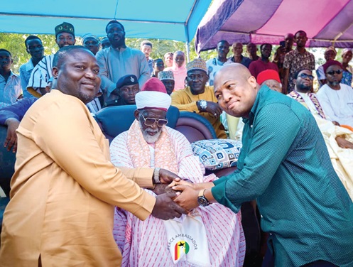 Samuel Okudzeto Ablakwa (right), Member of Parliament for North Tongu, thanking Sheikh Osman Nuhu Sharubutu (seated), National Chief Imam, after receiving the items (left)