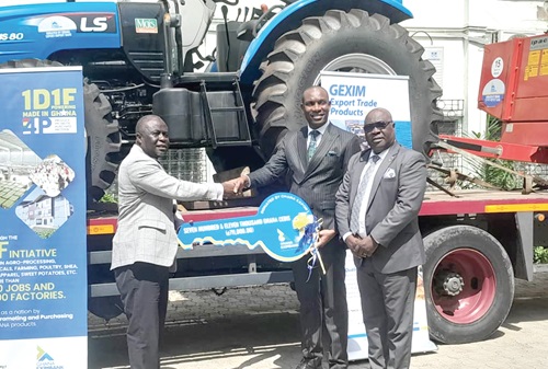Bright Evans Darko (2nd from right), Head of SME Banking of GEXIM, presenting a dummy key to Yaw Frimpong Addo, Deputy Minister of Food and Agriculture in charge of Crops, while Emmanuel Essilfie-Conduah, Head, Corporate Affairs of GEXIM Bank, looks on