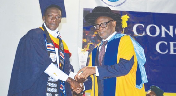 Professor Jophus Anamuah-Mensah presenting the overall  best student award to Samuel Amoah Gogoe 