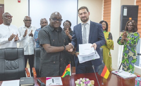 Michael Oquaye Jnr (left), CEO, GFZA, exchanging the signed grant agreement with Steffen Kuhl (right), MD, IFE, at the ceremony. Applauding are other officials of the GFZA