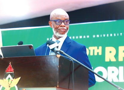 Joe Anokye (left), the Director-General of the National Communications Authority, speaking at a public lecture in Kumasi. Seated at the Great Hall of the KNUST are a section of the guests