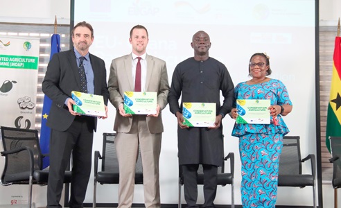 Jonas Claes (2nd from left), Deputy Head of EU Mission in Ghana, being assisted by Kingsley Kwasi Agyemang (2nd from right), Climate Change and Natural Resource Management Specialist, Ministry of Food and Agriculture; Daniel Krull (left), German Ambassador to Ghana, and Irene Susana Egyir (right), Dean, School of Agriculture, University of Ghana, Legon, to unveil the Conservation Agriculture Manual. Picture: ELVIS NII NOI DOWUONA