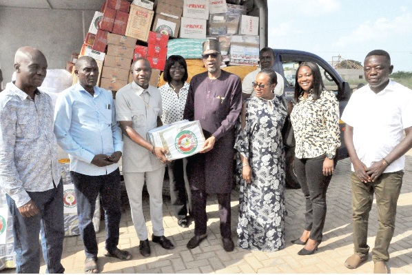Ambassador Baba Gana Wakil (in spectacles) presenting some of the items to Osborn Fenu (3rd from left), DCE of North Tongu, while some members of the visiting team and officials of the assembly look on