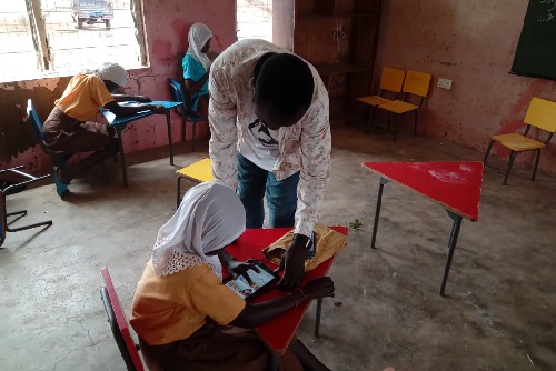 Some of the beneficiary children going through the reading exercise