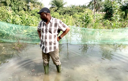 A dejected fish farmer counting his losses after the flood disaster
