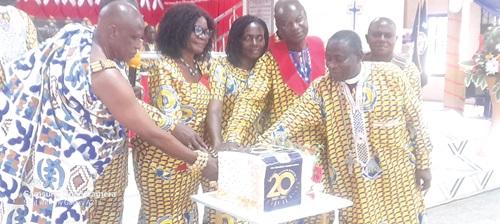 Rt Rev. Alfred Appiah Andam (right), Bishop of Wenchi Diocese, being assisted by Nana Asa Akompanin (left), Chief of Keobo, near Techiman, to cut the 20th anniversary cake