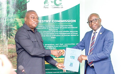 John Allotey (left), Chief Executive, Forestry Commission, exchanging  the agreement document with Prof. Elvis Asare-Bediako, Vice- Chancellor, UENR  