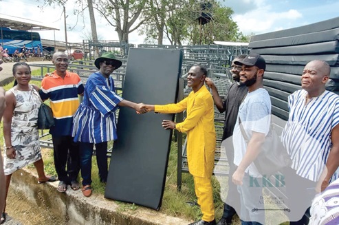 Kwasi Kwaning-Bosompem (in hat) making the presentation to the Headmaster of the school, Eric Afari Agyapong