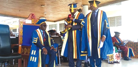Prof. Boakye (seated) being presented with his staff of authority
