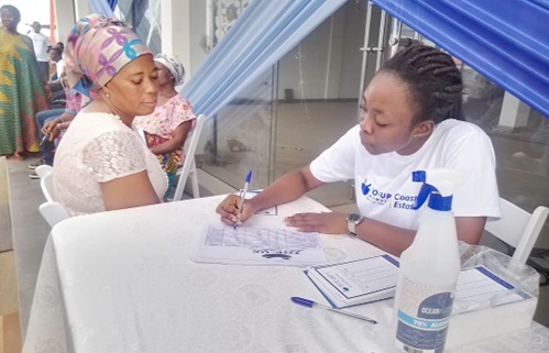 A health worker taking biodata of a resident