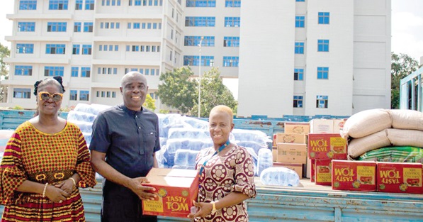 Prof. Abedenego F. O. Amartey (middle), Vice-Chancellor of UPSA, handing over the items to Comfort Doyoe Cudjoe (right), MP for Ada. With them is Dr Koryoe Anim-Wright, Registrar of the UPSA