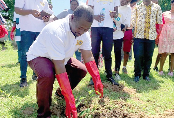 Wisdom Ahadzi, Upper East Regional Director, GTA, planting a tree to mark World Tourism Day. INSET: Kwame Gyasi, Central Regional Director of the GTA, and Christopher Odame, President of the club, planting a tree to begin the exercise 
