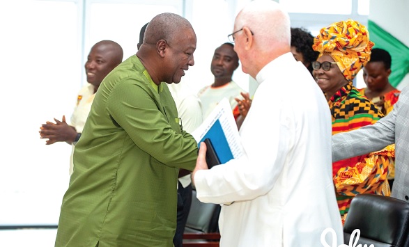 John Dramani Mahama (left) and Fr  Andrew Campbell exchanging pleasantries with some senior citizens at the event