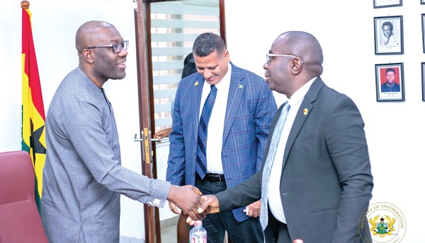 Kojo Oppong Nkrumah (left), welcoming  Kwame McCoy (Right), Minister of Information, Guyana, while Collins Croal, Minister of Housing and Water, Guyana, looks on