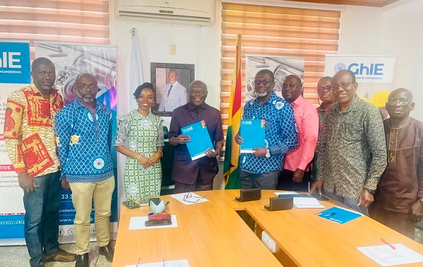 Ehunabobrim Prah Agyensaim (4th from left) and Kwabena Bempong (5th from right), displaying the signed MoU, while other GhIE Council members look on