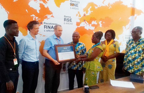 Mavis Ayisi (3rd from right) Head, Taxpayer Service, presenting a citation to Robert Oram (3rd from left),  Country Manager, Hapag Lloyd Ghana Ltd