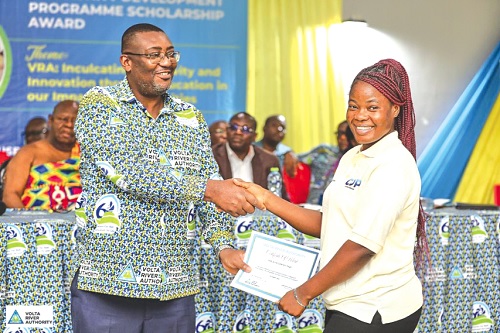 Kenneth Arthur (left), VRA Deputy Chief Executive for Services, presenting a certificate to a beneficiary  