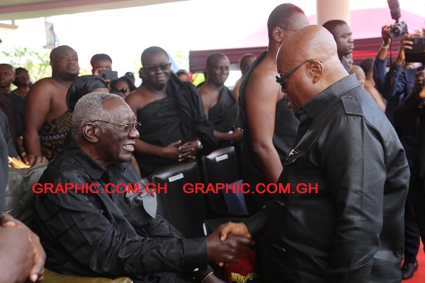 President Nana Akufo-Addo in a handshake with former President J.A. Kufuor at the event