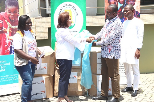 Laura Cristina Delvalle (2nd from left), National Director, World Vision Ghana, handing over the Personal Protective Equipment to Dr Lawrence Ofori Boadu (2nd from right), acting Director, Institutional Care Division, Ghana Health Service. Picture: ELVIS NII NOI DOWUONA