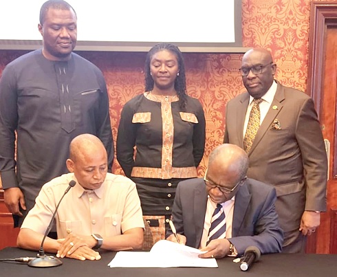 Dr Divine Ndonbi Banyubala (seated right), Registrar of the Medical and Dental Council of Ghana, and Dr William Kedjanyi, President, GDDA-UK, signing the agreement. Looking on is Papa Owusu-Ankomah (standing right), Ghana’s High Commissioner to the UK and Northern Ireland 