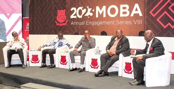 Moses Kwesi Baiden Jnr (right), CEO, Margins Group Ltd, answering questions in the forum.  Looking on are Prof. Philip Ebow Bondzi-Simpson (left), Vice-Chancellor, Methodist University; Dr George Acheampong (2nd from left), Senior Lecturer, Department of Marketing and Entrepreneurship, UG; Nana Dr Kofi Annan Afer I (middle), IT Consultant, and Dr Christian Owoo (2nd from right), Senior Lecturer, UG Medical School. Picture: ERNEST KODZI
