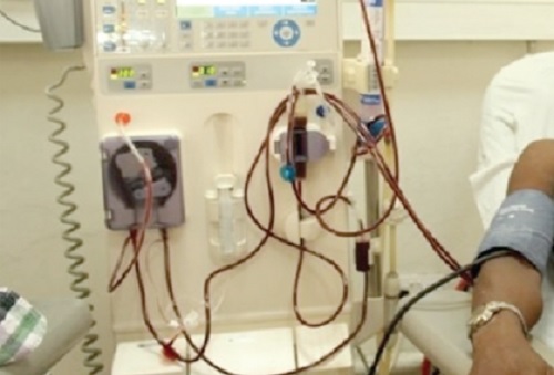 A patient strapped to a dialysis machine