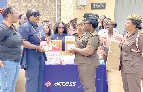 Josephine Eva Arthur(2nd from left), the Zonal Head of Retail Banking of Access Bank, handing over the medical supplies to ADP Victoria Adzewodah of the Nsawam Prisons