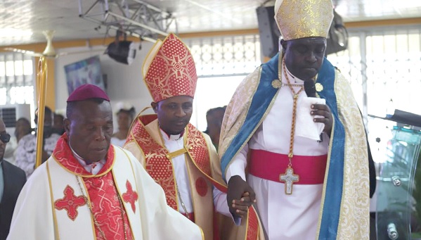 Bishop Samuel Darley Arthur (middle) being led to the induction ceremony by Archbishop Agyeman Badu (right), President, ICCMGB. With them is Bishop James Akwasi Amoako