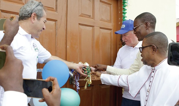 Nick Hutchinson (left), MD of FMGL, being assisted by Venerable Samuel Hanson-Addy, Chairman of the school, and Isaac Ashai Odamtten, MP for Tema East, to cut the tape