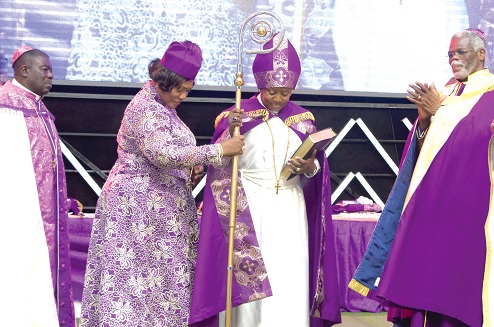 Lady Bishop Dodoo-Amoo (2nd from right) being presented with a staff by Lady Bishop Naana Addae-Mensah, co-founder of GLIC. Looking on is Bishop Henry Dodoo-Amoo (right) and Bishop Ambrose Boafoh