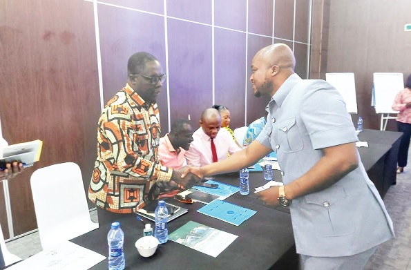 Yohane Amarh Ashitey (right), Tema MCE, interacting with Amos Donkor, MD of Tema Lube Oil Company, after the stakeholders meeting