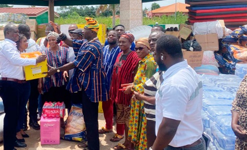 Daniel Ayi (left), Vice-President of Operations, Genser Energy Ghana Ltd, handing over the items to Togbe Agorvie Gli II (arrowed), Chief of Gbenuakofe