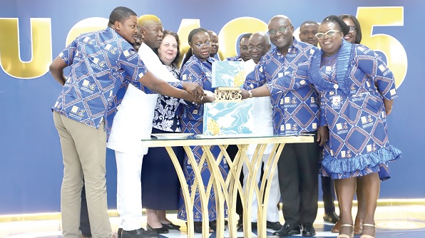 Prof. Nana Aba Appiah Amfo (4th from left), Vice-Chancellor, University of Ghana, Legon, being supported by Mahama Asei Seini (2nd from left), a Deputy Minister of Health, Dr Anarfi Asamoa-Baah (3rd from right), Board Chairman, UGMC, and Dr Darius Osei (2nd from right), Chief Executive Officer, UGMC, to cut the anniversary cake. Picture: SAMUEL TEI ADANO