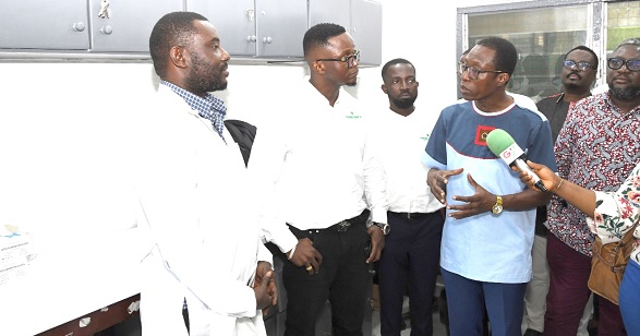 Dr Harry Akoto (right), acting Medical Director of the Korle Bu Teaching Hospital, briefing Emmanuel Teye Kenney ( 2nd from left), CEO of Flokefama, and some officials of the Blood Bank during the handing over ceremony